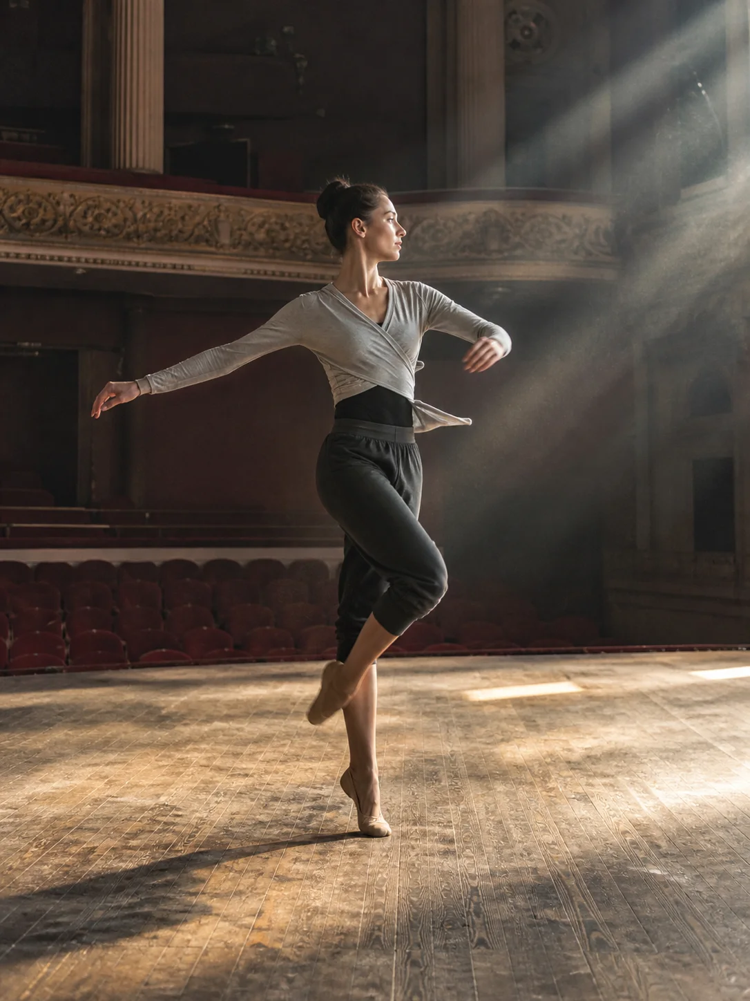 Ballet dancer rehearsing on an old theater stage
