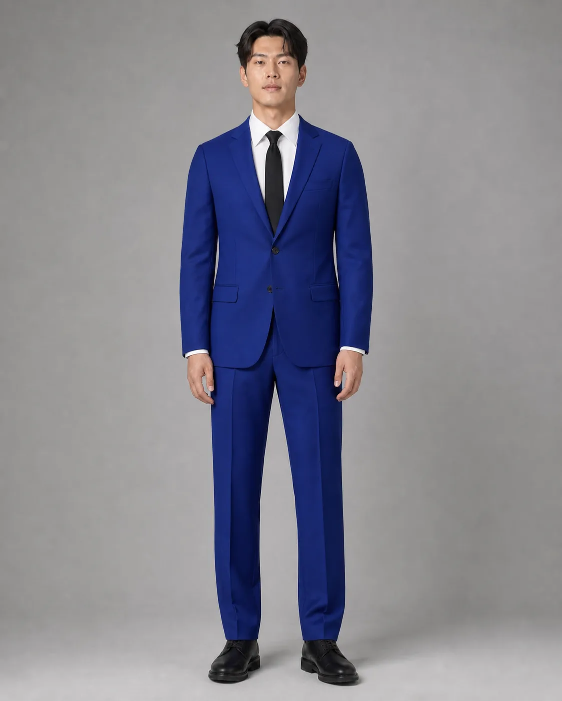 The same model, same pose, wearing a cobalt tailored suit