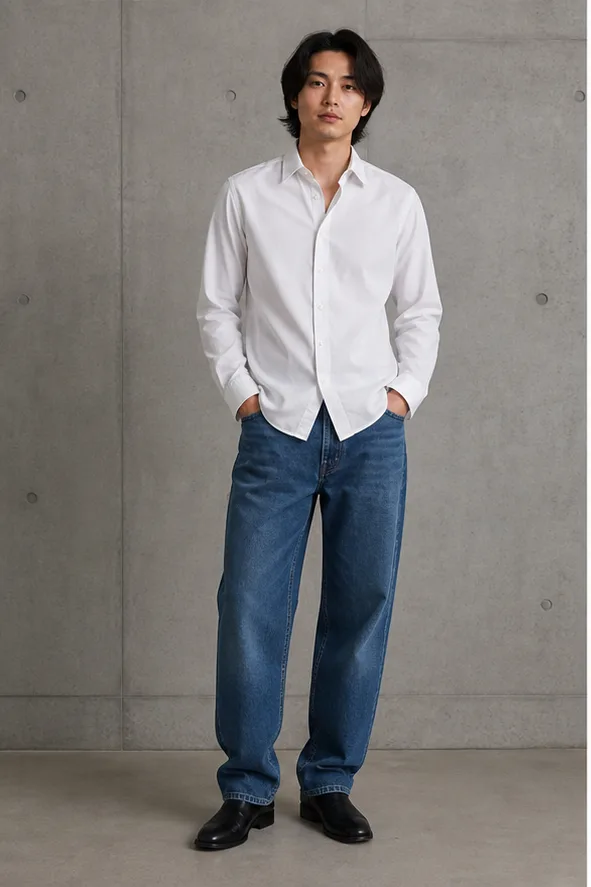 On-model base shot: an adult East Asian man in a white shirt and relaxed jeans in a concrete studio